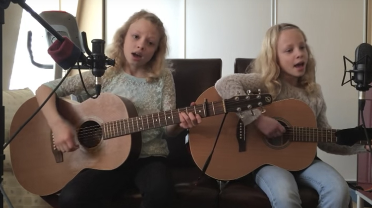 blonde twins playing guitar and singing