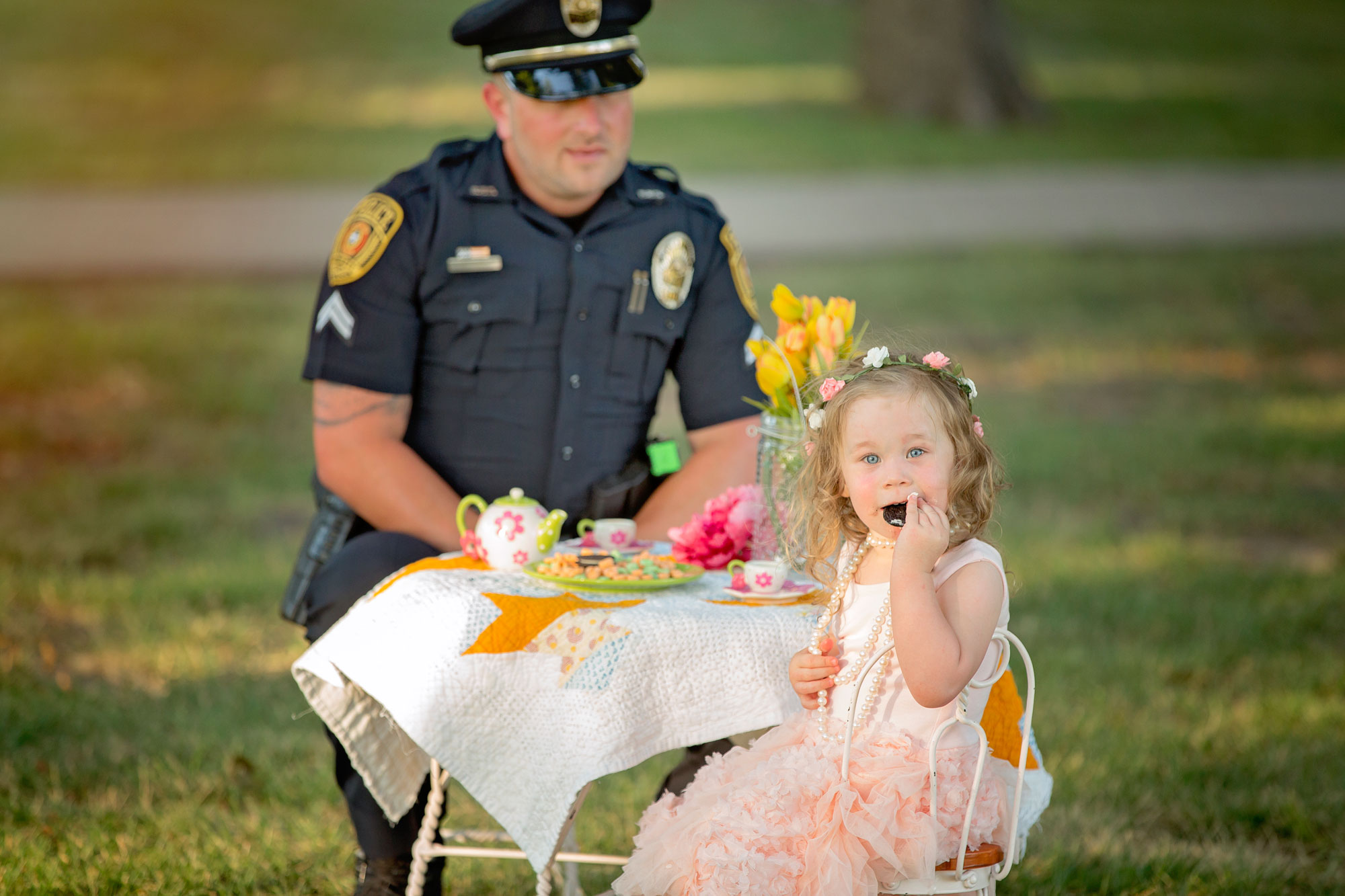 Little girl with cookie at tea party