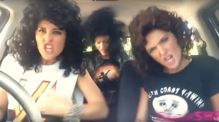 girls in wigs in car singing