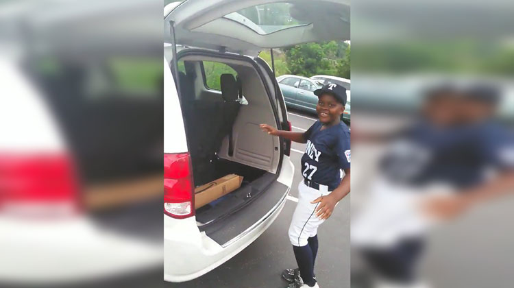 boy in baseball gear gets surprise in trunk of car
