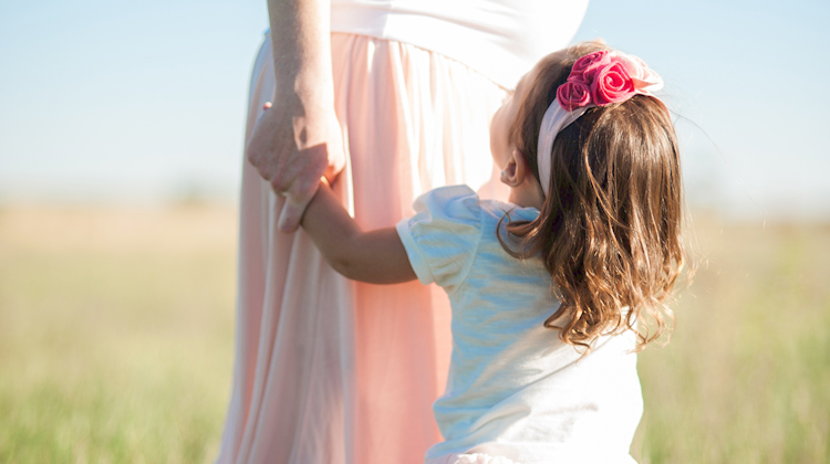 Mom holding daughter's hand