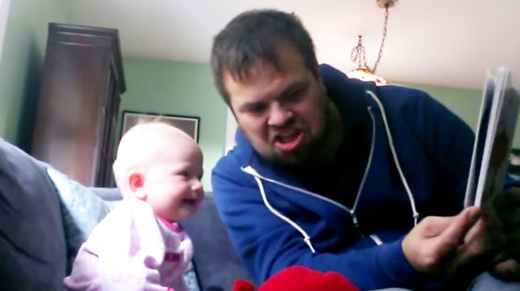 uncle makes funny face while laughing baby looks at book