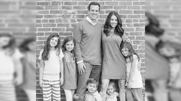 husband wife 4 girls and 1 boy in black and white picture