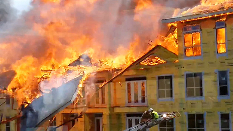 Firefighters saving man from burning building