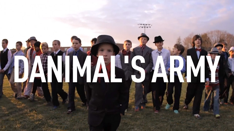 Danny Keefe with his pee-wee football team in suits on field