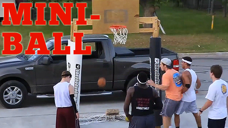 College dudes playing on miniature basketball goals