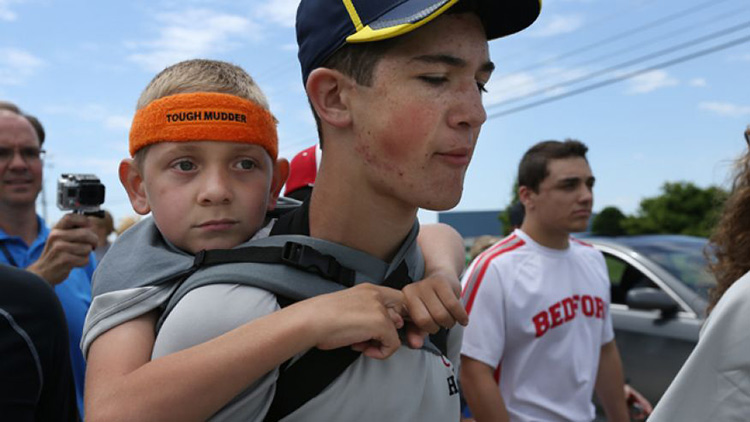 Older brother carrying younger brother on back