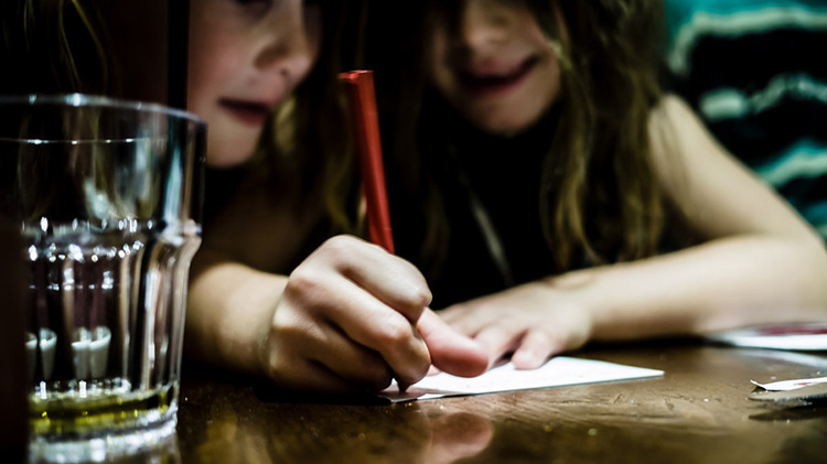 Girls writing on paper.