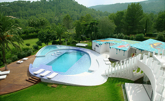 Spanish home with colorful roof and long flight of stairs to pool