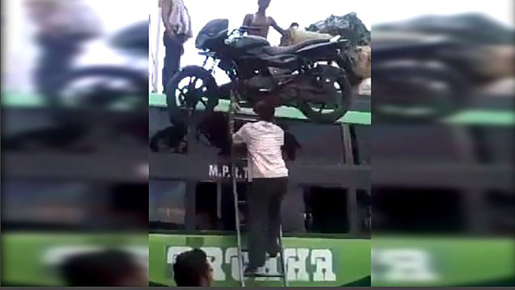 man balancing motorcycle on head