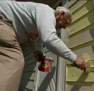 elderly volunteer painting home