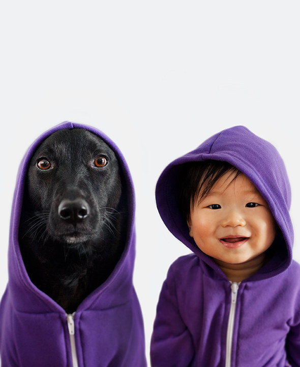 baby and dog wearing matching purple hoodies