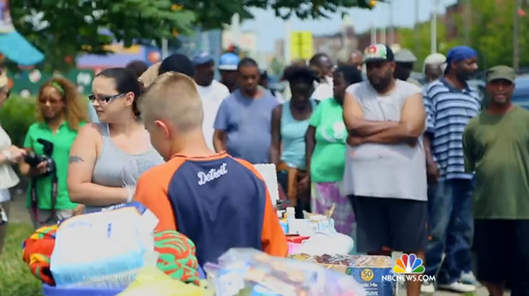 Robby Eimers with long line of homeless waiting for food.