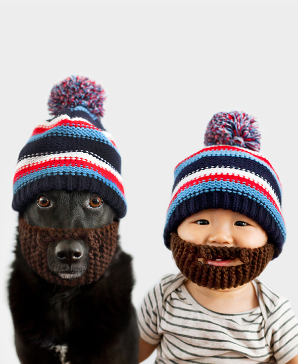 baby and dog wearing beanies with fake beards attached