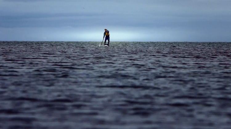 Bruce Kirkby on standup paddleboard in open ocean