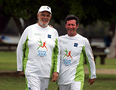 james harrison holding queens baton as an honor of being an oam