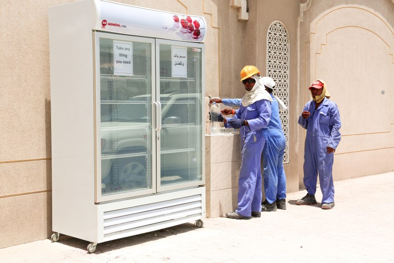qatari family leaves stocked fridge outside for construction workers in the heat