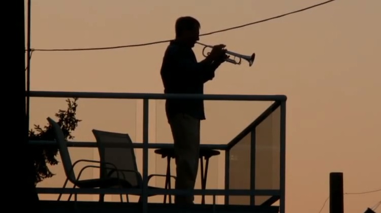 man plays instrument, brings neighbors to a halt