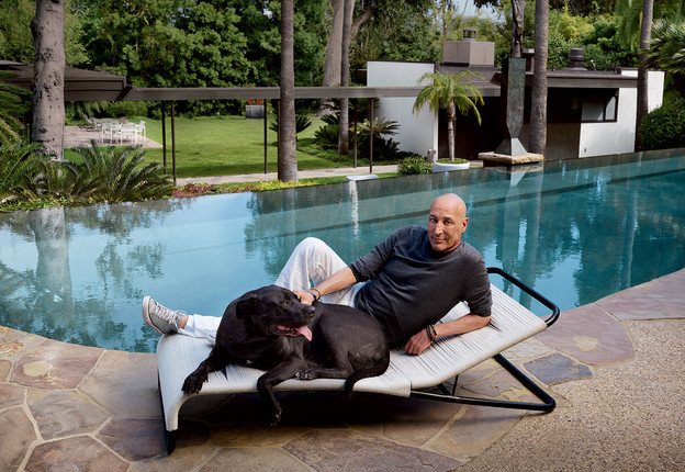 sam simon by his pool with a dog