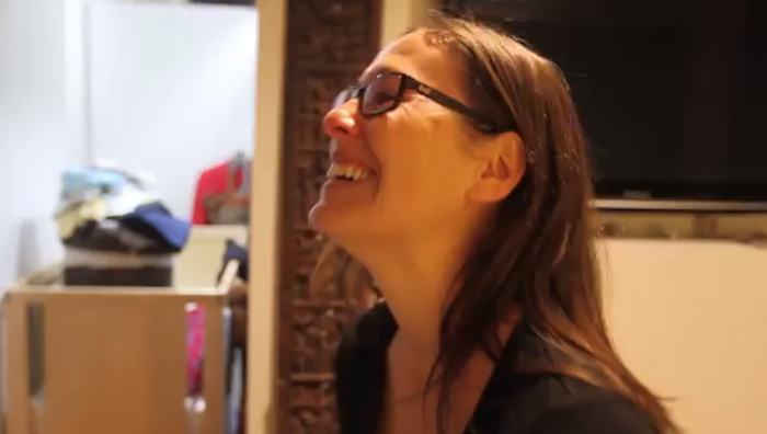 wife smiling at baby portraits
