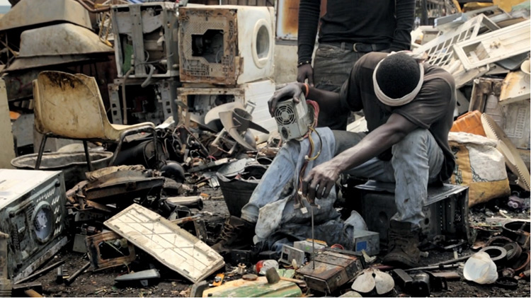 Man in an electronic waste dumping ground.