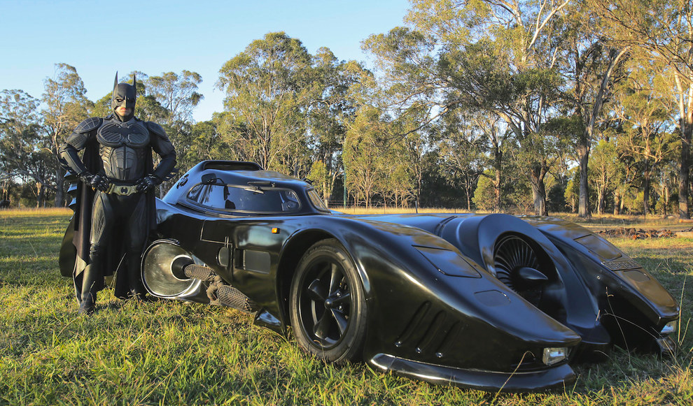 batman next to batmobile 