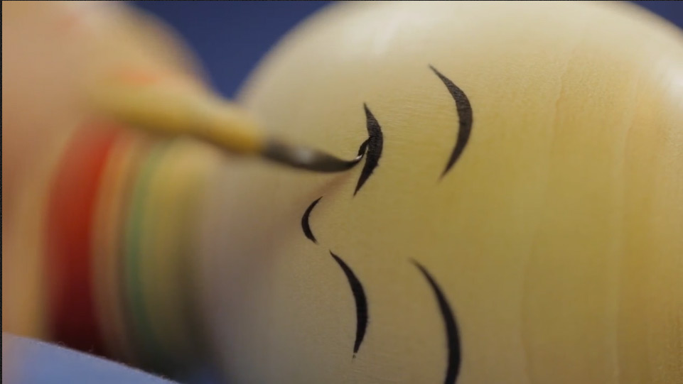 Mr. Okazaki painting the delicate face on the Kokeshi doll