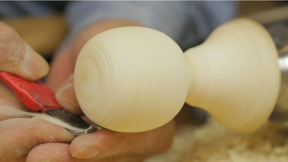 Mr. Okazaki shaping the doll head on the lathe