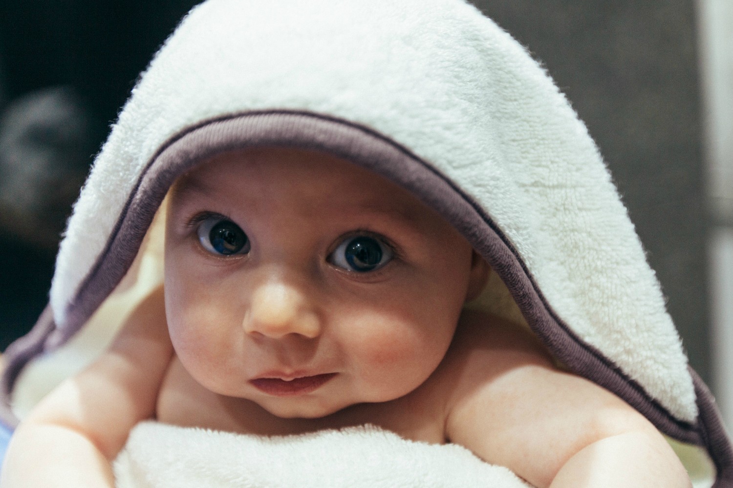 baby with blanket on his head