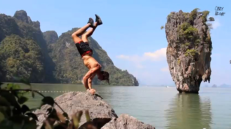 man does crazy handstand in asia