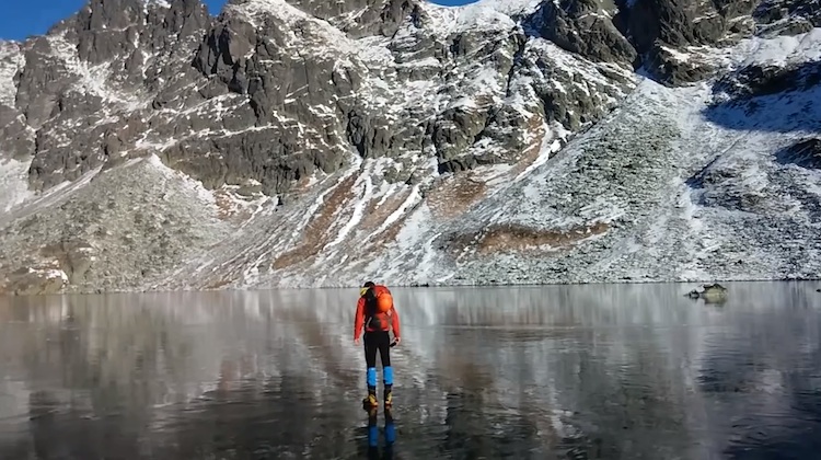 man walking on frozen lake