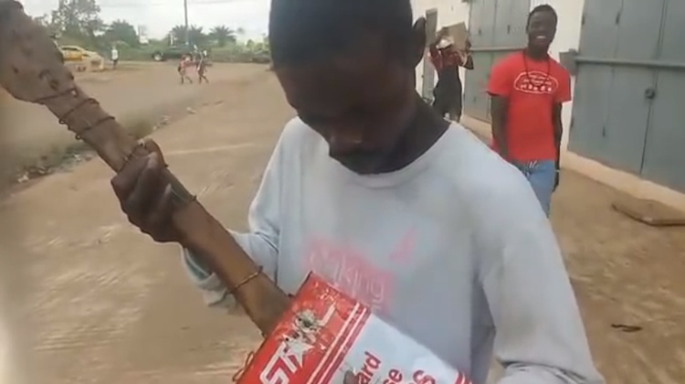 liberian street musician with makeshift guitar