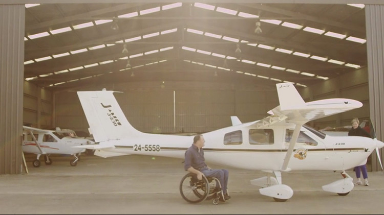Dave Jacka in wheelchair outside of his airplane