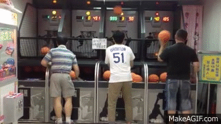 Asian man casually walking away after dominating arcade basketball