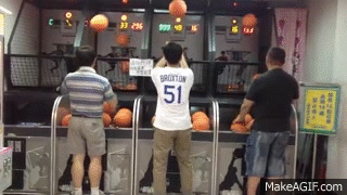 Asian man making it rain on basketball arcade game