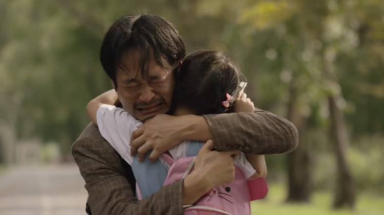 Dad embracing daughter in tears