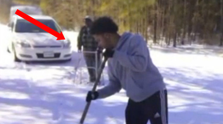 Tommy Adams shoveling snow for elderly man