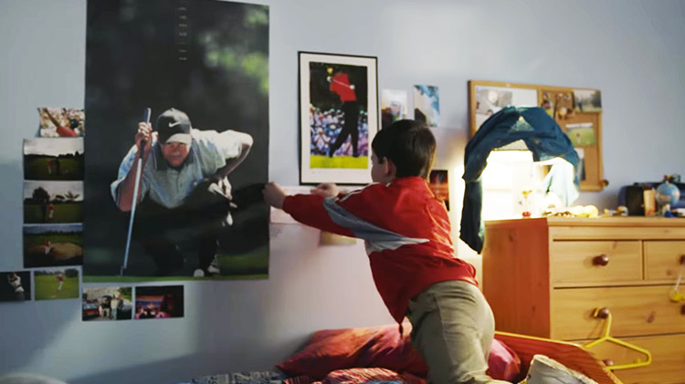 Young Rory McIlroy pinning a Tiger Woods poster to his wall