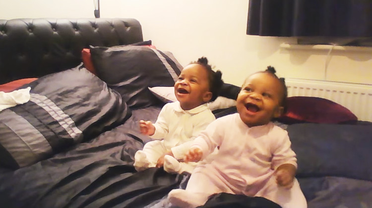 twin baby girls dancing to mom singing tune