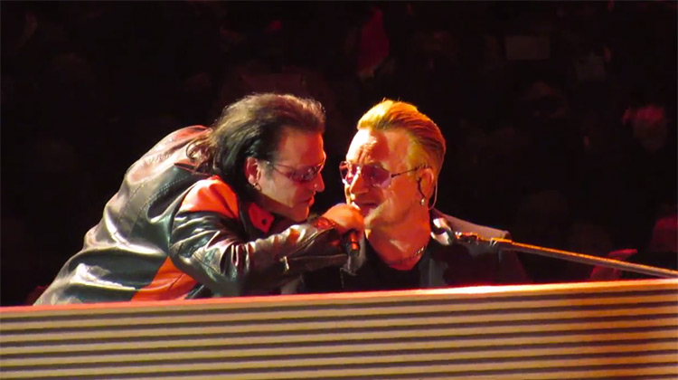 Bono with his impersonator singing at piano in Los Angeles