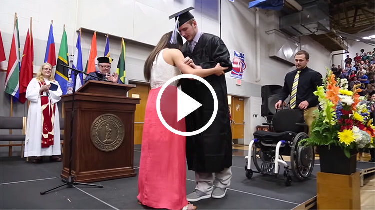 Chris Norton walking across stage with fiance