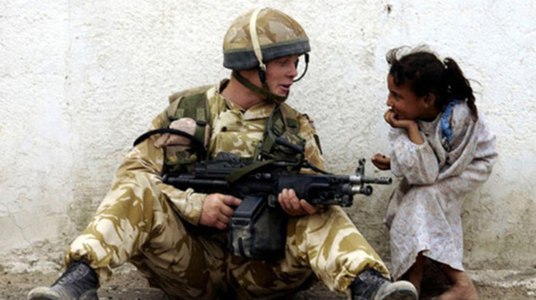 Soldier laughing with little girl