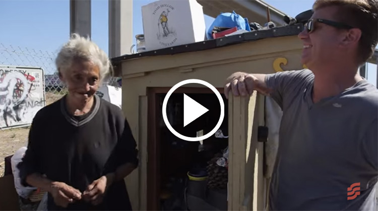 Greg Kloehn with homeless woman and miniature home he built