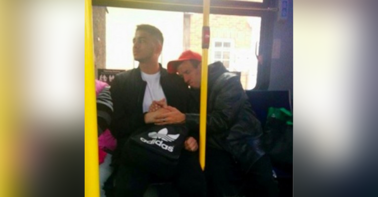 robert and godfrey holding hands on their bus trip