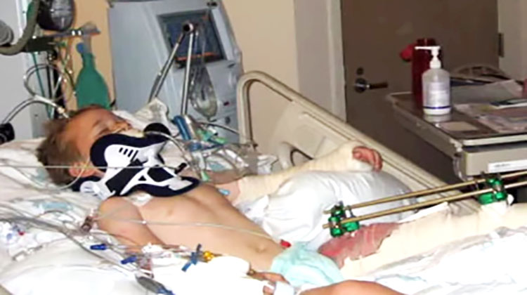 Boy in coma in hospital bed