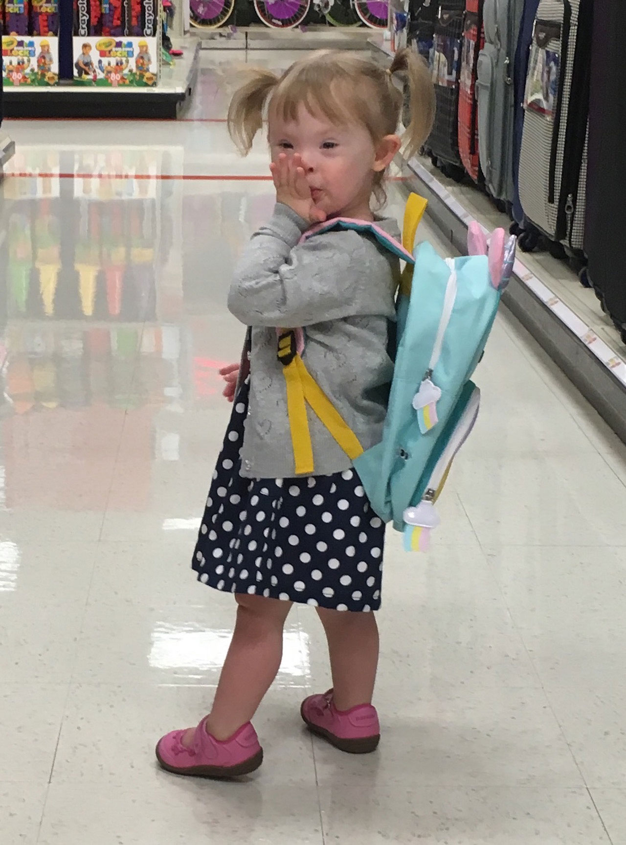 little preschool girl with pigtails and backpack