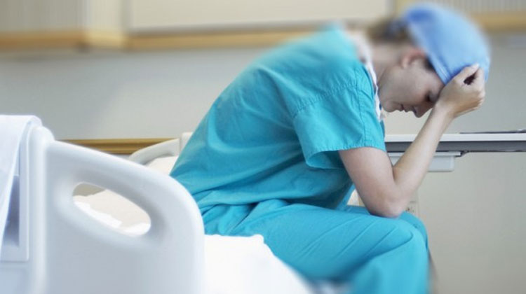 nurse sitting on a hospital bed
