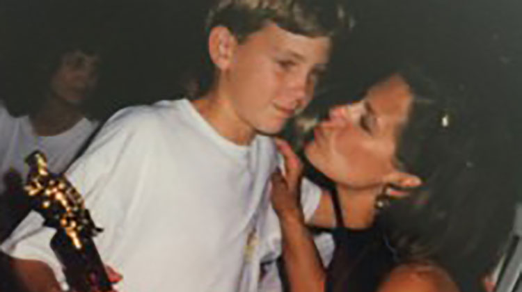 Mom kissing son