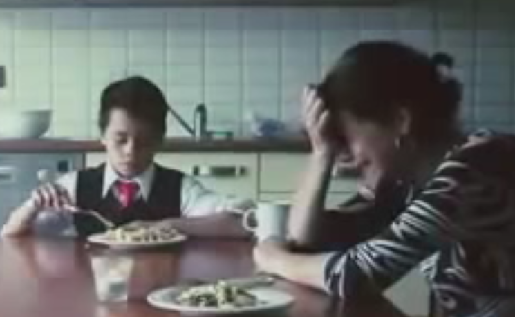 Boy with mom crying at dinner table