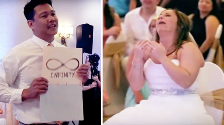 groom holds up sign for crying bride